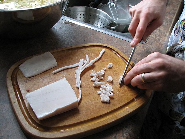 cutting strips of fat to lard meat