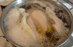boiling chicken in a pot