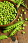 Fresh green peas in a wooden bowl