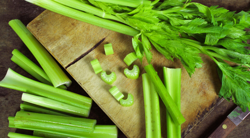 Raw celery on cutting board