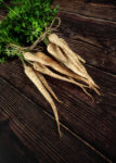Bunch of parsnips on wooden background