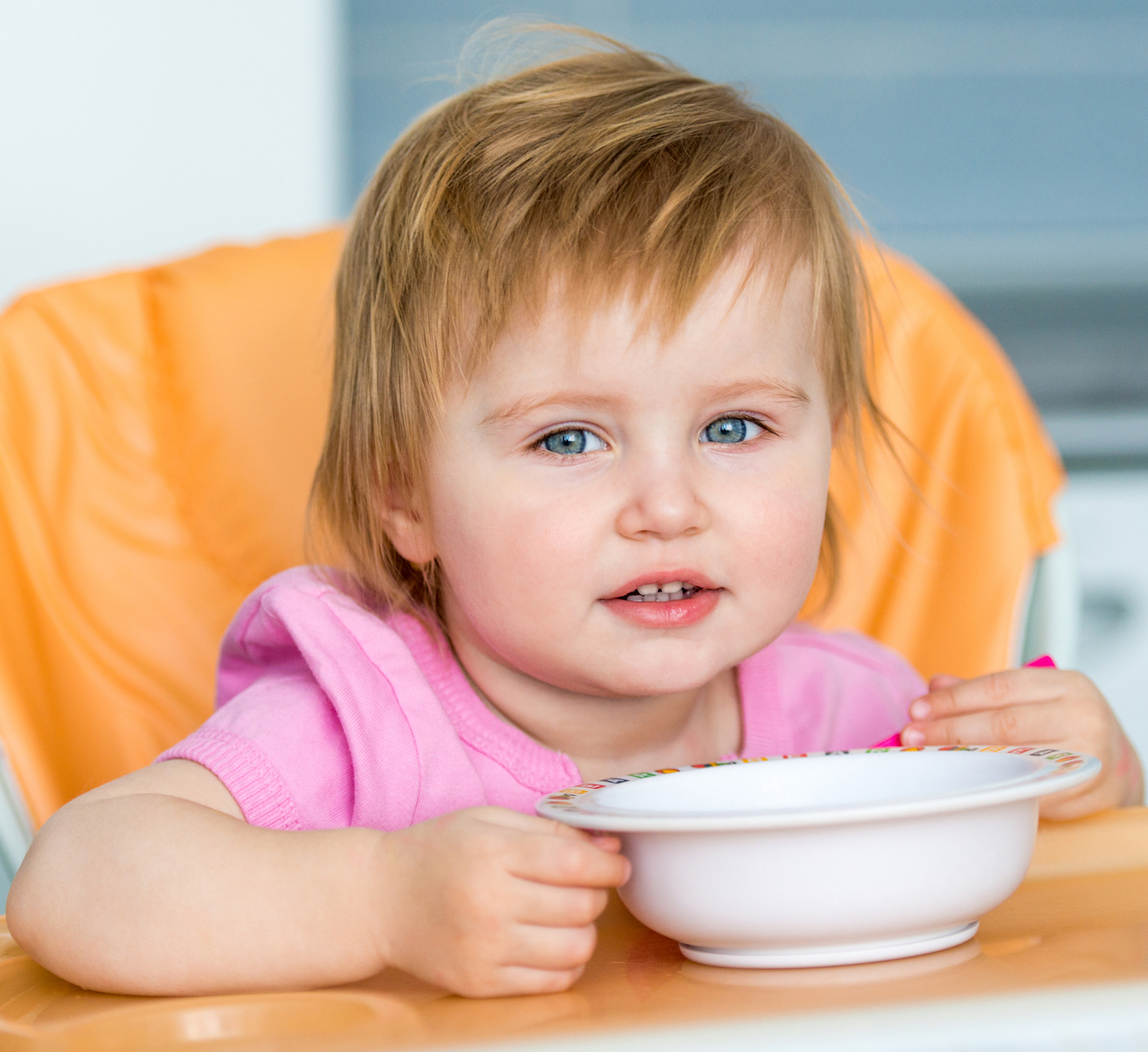Young child eating from bowl.